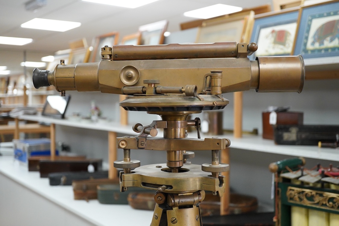 An early 20th century surveyor’s brass theodolite by Stanley, Holborn, London, serial number 27108, on original brass mounted tripod with oak legs, overall height 170cm